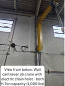 View from below of a wall cantilever jib crane with electric chain hoist - both 1/2 Ton capacity (1,000 lbs)